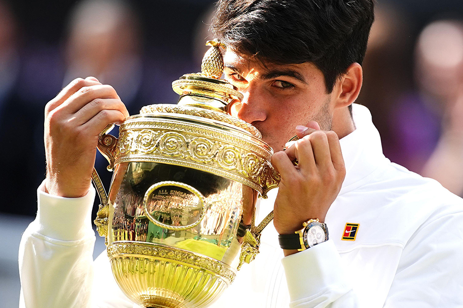 Carlos Alcaraz celebrates with the trophy after victory in the Gentlemen's Singles Final against Novak Djokovic (not pictured) on day fourteen of the 2024 Wimbledon Championships at the All England Lawn Tennis and Croquet Club, London. 